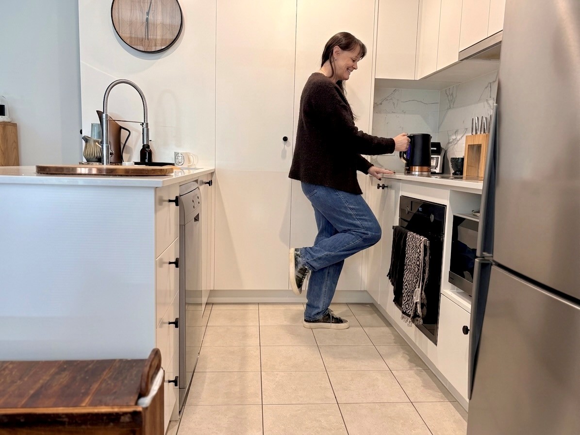 Person practicing everyday strength and balance activities in the kitchen as part of the LiFE Program.